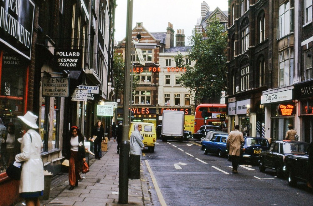 a group of people walking on a city street