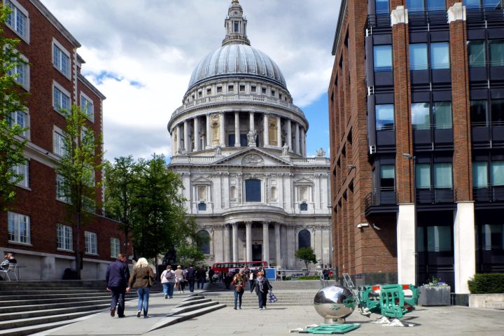 a group of people walking in front of a building